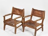 two brown leather chairs with wooden arms and arms on a white background
