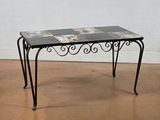 a small table with a glass top on a wooden floor