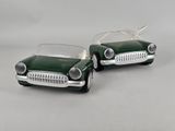 two toy cars sitting side by side on a white surface