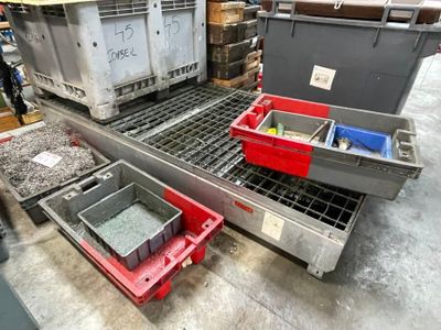 many containers that are sitting on a conveyor belt