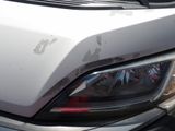 a close up of a car ' s headlight with rust on it