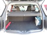 the back of a car with the trunk open and luggage in the trunk