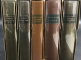 four books are stacked on top of each other on a table