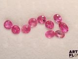 a close up of a group of pink stones on a white surface