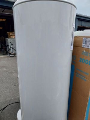 une poubelle blanche posée à côté d'une pile de cartons