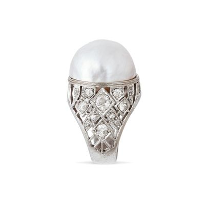 a close up of a pearl and diamond ring on a white background