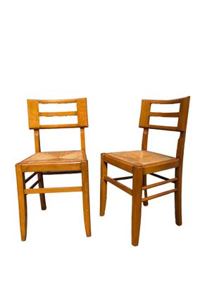 pair of wooden chairs against a white background