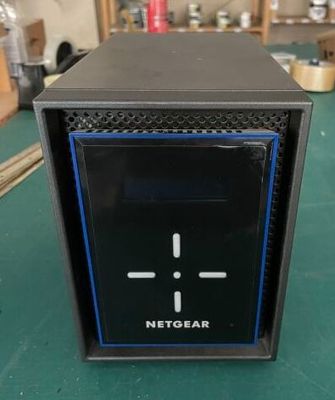 the netgear is sitting on a table with a green table cloth