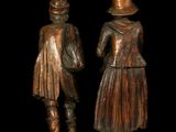 two bronze statues of a man and a woman standing next to each other