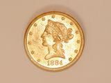 a close up of a gold coin with a woman ' s head on it