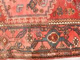 an image of a red and blue rug with a pattern on it