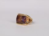 a close up of a gold ring with an amethorate stone