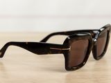 a close up of a pair of sunglasses on a wooden table