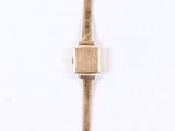 gold plated cross pendant on a white background with a white background