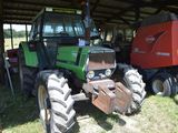 a tractor that is parked next to a trailer
