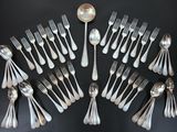 a lot of silver spoons and forks arranged in a circle