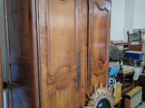 a wooden armoire with a sunburst on top of it