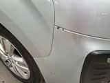 a close up of a car ' s front bumper and tire