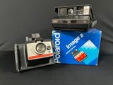 a polaroid camera sitting on top of a box