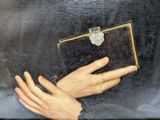 painting of a woman ' s hand holding a book with a ring on it