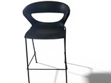 a black chair that is sitting in front of a white wall