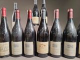 several bottles of wine are lined up on a table