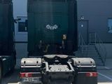 two large trucks parked in front of a building