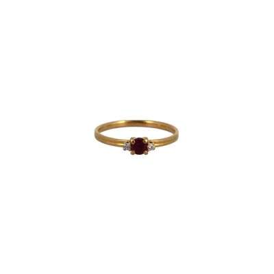 a gold ring with a ruby stone and two diamonds