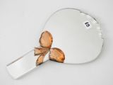 a heart shaped mirror with a brown bow on it