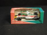 a toy car in a box on a black surface