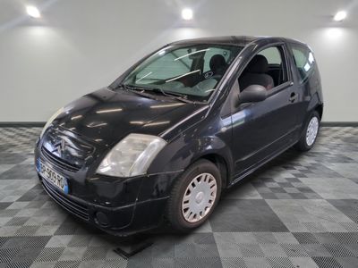 a picture of a small black car parked in a garage