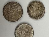 four different types of coins are shown on a white surface