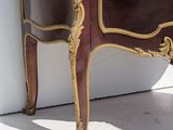 a small cabinet with a mirror on top of it