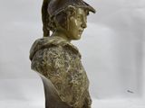 bronze bust of a man wearing a helmet on a marble base