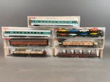 three toy trains that are sitting in a box
