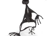a metal sculpture of a bird that is sitting on a branch