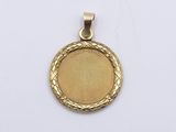 a close up of a gold medal on a white surface