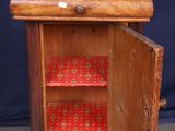 a small wooden cabinet with a green top