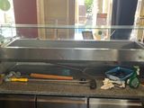 stainless steel counter top with tools on it in front of a window