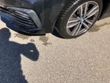 a black car parked on the side of the road with a shadow of a man