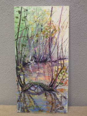 an oil painting of a river in the woods on a wooden table