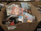 a cardboard box full of dvds and other movies