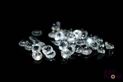 some very pretty diamonds on a black surface with a black background