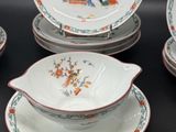 four plates and a bowl on a black table
