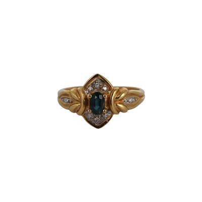 a close up of a gold ring with a blue stone and diamonds