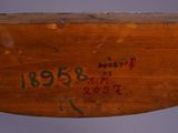 a close up of a piece of wood with writing on it