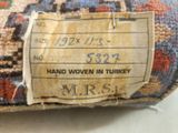 a label on a piece of fabric that says hand woven in turkey