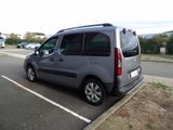 a silver van parked in a parking lot next to a curb