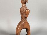 an image of a wooden statue of a man holding a ball