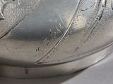 a close up of a silver vase with a star design on it